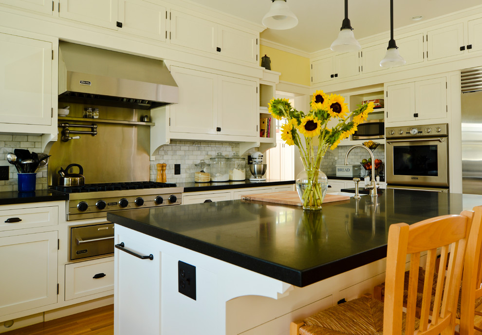 Example of an arts and crafts kitchen design in San Francisco with shaker cabinets, white cabinets, white backsplash, stainless steel appliances and marble backsplash