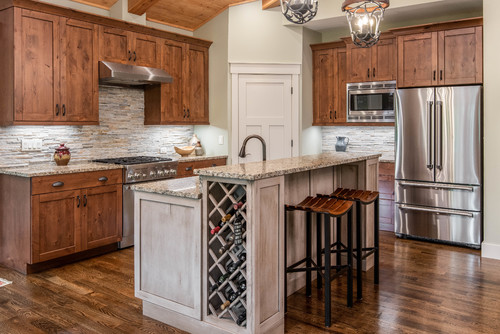 Nature's Palette: Multicolored Stone Tile Backsplash with Wood and Light Gray Wood Cabinets