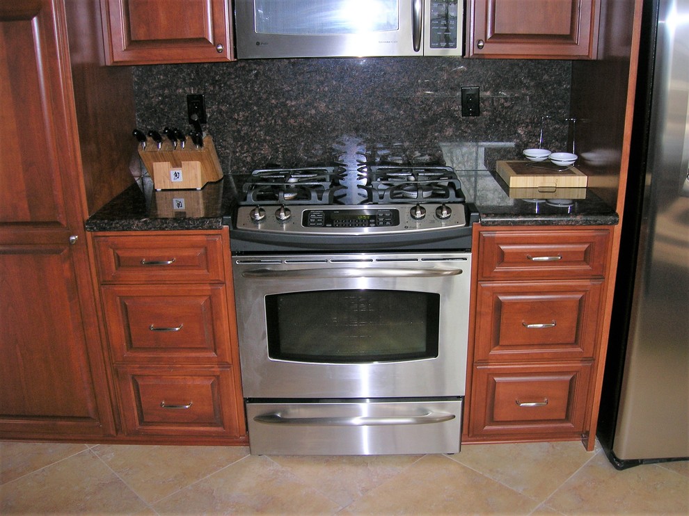 Klassisk inredning av ett mellanstort flerfärgad flerfärgat kök, med en undermonterad diskho, luckor med upphöjd panel, granitbänkskiva, flerfärgad stänkskydd, stänkskydd i skiffer, rostfria vitvaror, klinkergolv i keramik, en halv köksö, flerfärgat golv och skåp i mellenmörkt trä