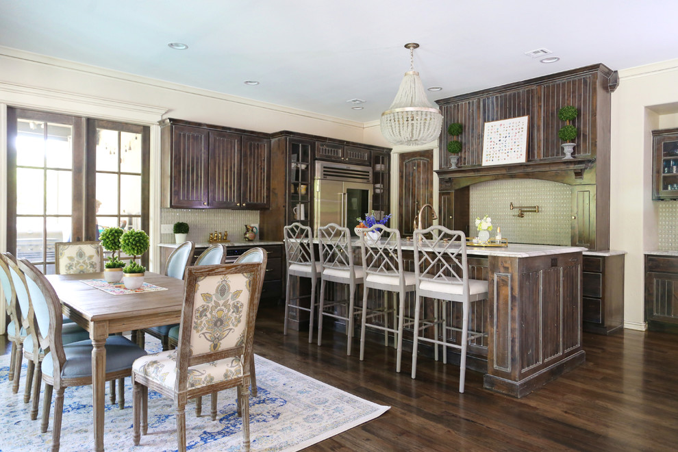 Example of a classic l-shaped dark wood floor and brown floor eat-in kitchen design in Other with recessed-panel cabinets, dark wood cabinets, beige backsplash, stainless steel appliances, an island and white countertops