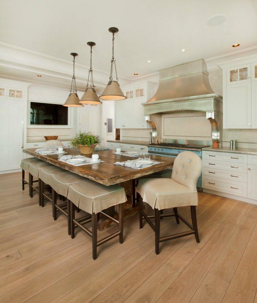 Large elegant u-shaped light wood floor and brown floor eat-in kitchen photo in Other with white cabinets, colored appliances, shaker cabinets and gray countertops