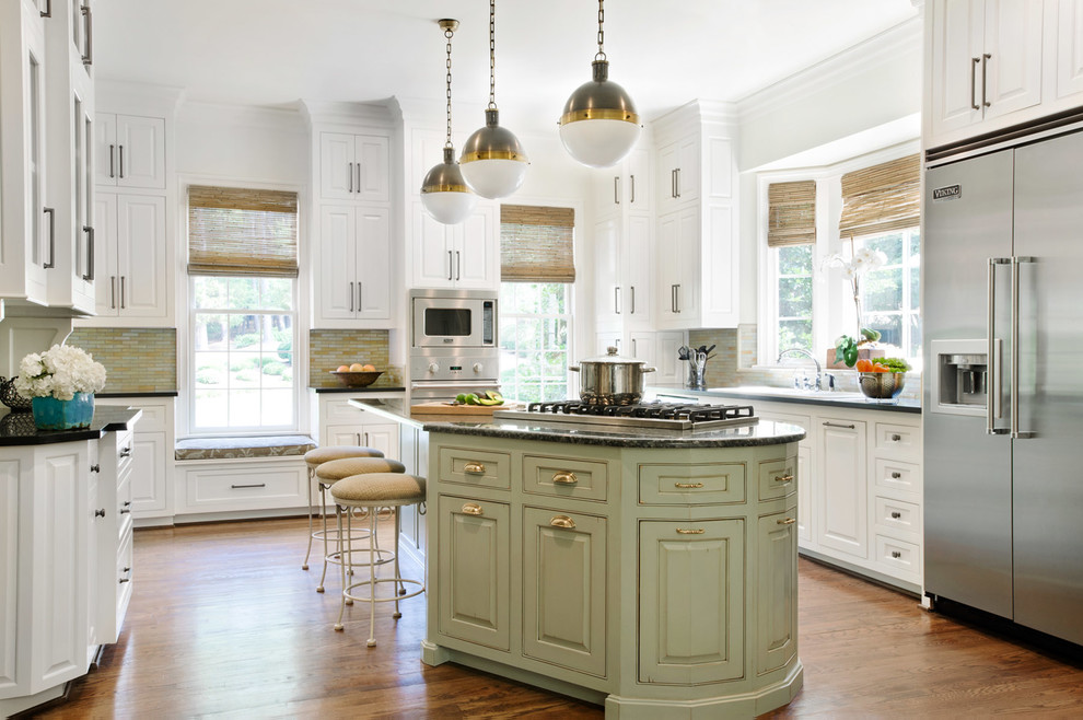 Inspiration for a classic u-shaped kitchen/diner in Charlotte with white cabinets, multi-coloured splashback, mosaic tiled splashback, stainless steel appliances, medium hardwood flooring, an island, a submerged sink, granite worktops, brown floors and beaded cabinets.