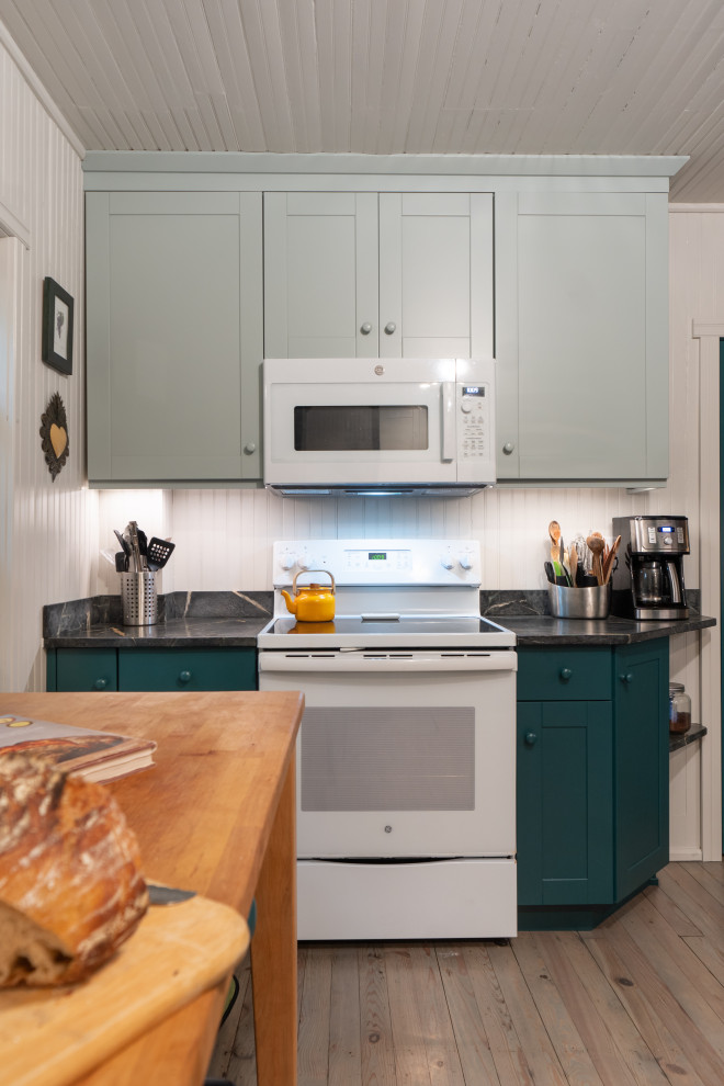 This is an example of a small farmhouse galley kitchen/diner in Other with a submerged sink, shaker cabinets, green cabinets, soapstone worktops, black splashback, light hardwood flooring, no island, beige floors, black worktops and a wood ceiling.