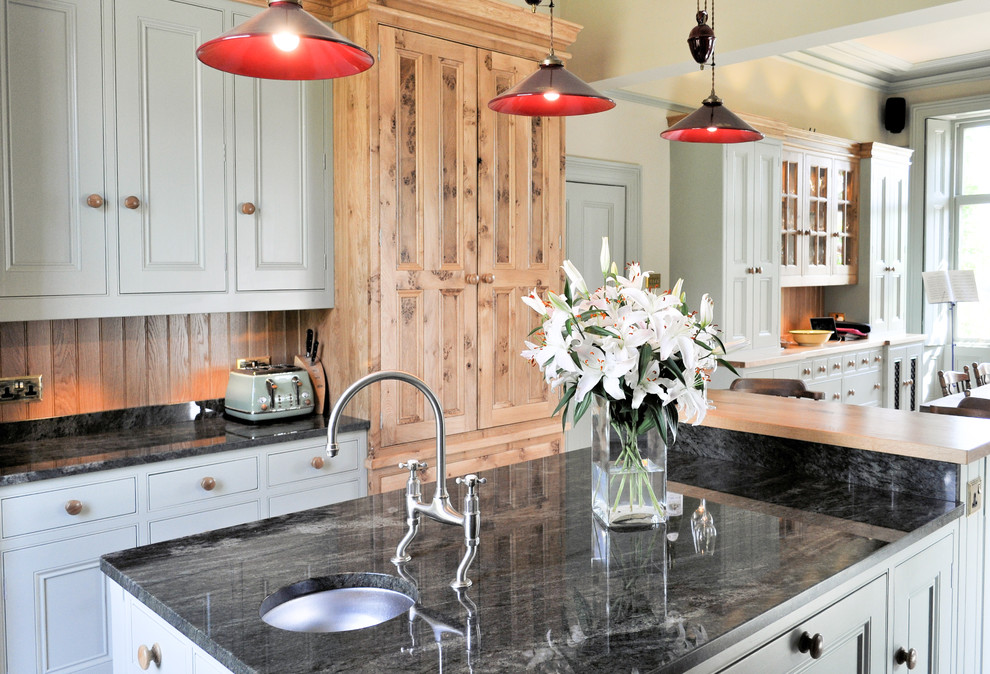 This is an example of a large traditional kitchen/diner in Other with a submerged sink, beaded cabinets, granite worktops, ceramic flooring and an island.