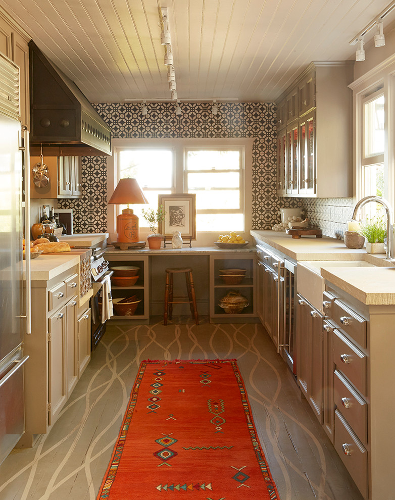 This is an example of a medium sized farmhouse kitchen/diner in Sacramento with stainless steel appliances, painted wood flooring and no island.