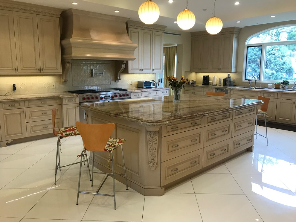 Photo of a medium sized classic single-wall enclosed kitchen in Los Angeles with a submerged sink, beaded cabinets, beige cabinets, granite worktops, beige splashback, ceramic splashback, porcelain flooring, an island, white floors and brown worktops.