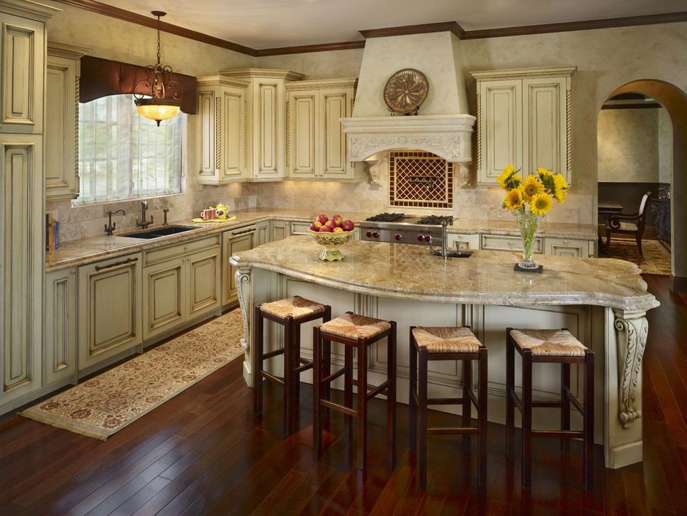 This is an example of a classic kitchen in Denver with a double-bowl sink, beige cabinets and beige splashback.
