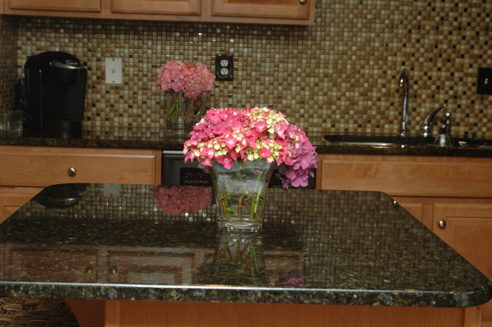 Kitchen photo in Philadelphia with a double-bowl sink, raised-panel cabinets, light wood cabinets, brown backsplash, ceramic backsplash, stainless steel appliances and an island