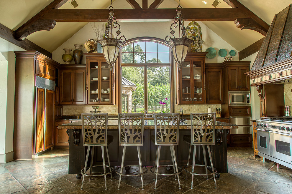 Photo of a large traditional kitchen in Houston with an island, recessed-panel cabinets, dark wood cabinets and beige splashback.