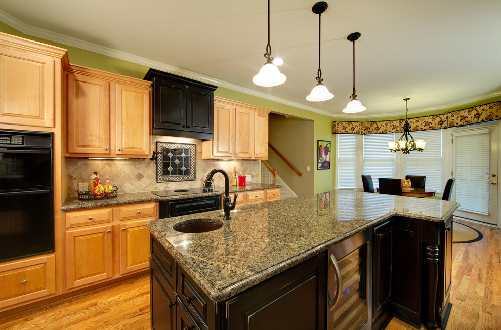 Eat-in kitchen - small traditional u-shaped medium tone wood floor eat-in kitchen idea in Other with granite countertops, an undermount sink, raised-panel cabinets, beige backsplash, an island and travertine backsplash