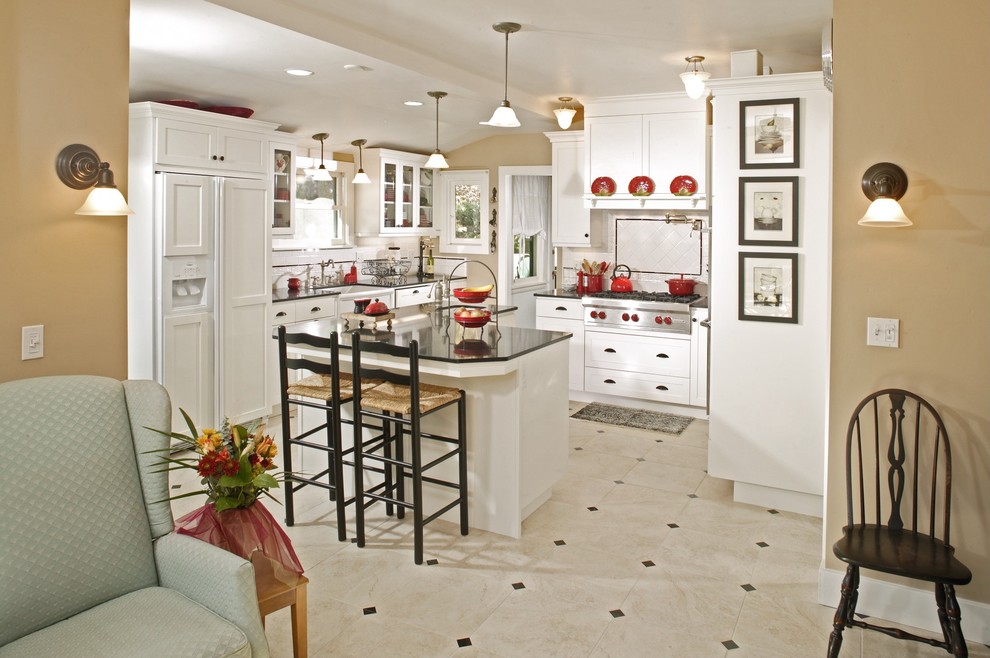 Inspiration for a large traditional u-shaped kitchen/diner in Sacramento with shaker cabinets, white cabinets, white splashback, metro tiled splashback, white appliances, vinyl flooring, an island, a submerged sink and granite worktops.