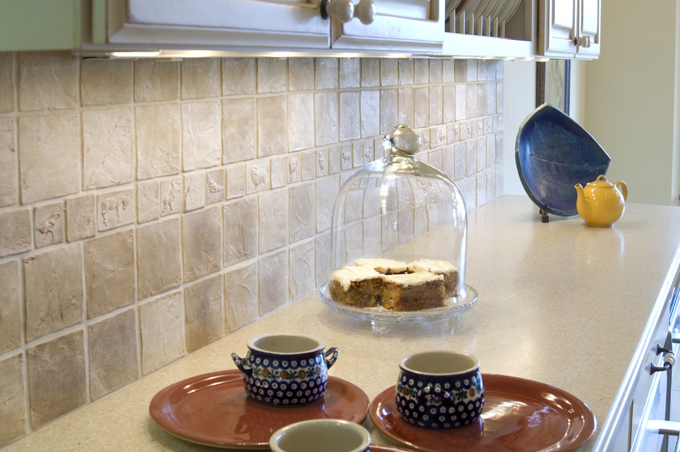 Kitchen - traditional kitchen idea in Other with solid surface countertops and beige backsplash