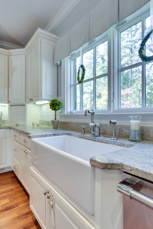 Klassische Wohnküche mit profilierten Schrankfronten, weißen Schränken und Küchengeräten aus Edelstahl in Washington, D.C.