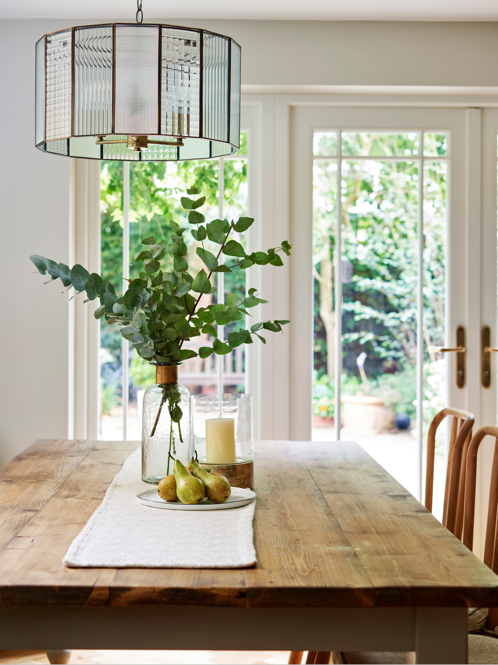 Natural Light Streams into an Elegant Green Kitchen with Painted Shaker  Cabinets