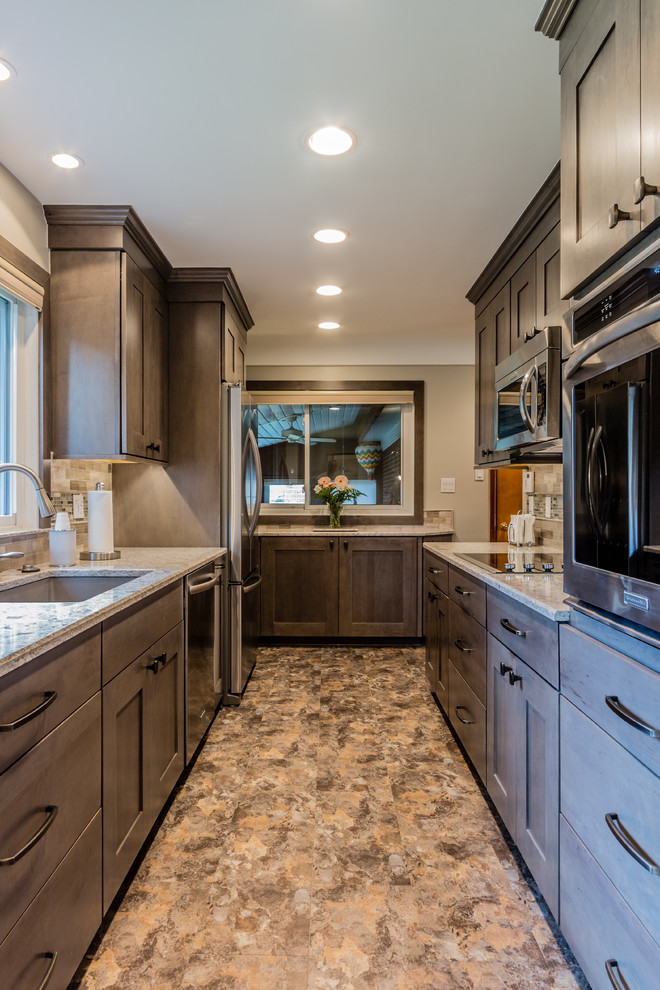 Example of a mid-sized classic galley linoleum floor enclosed kitchen design in Detroit with an undermount sink, shaker cabinets, gray cabinets, quartz countertops, gray backsplash, subway tile backsplash, stainless steel appliances and no island