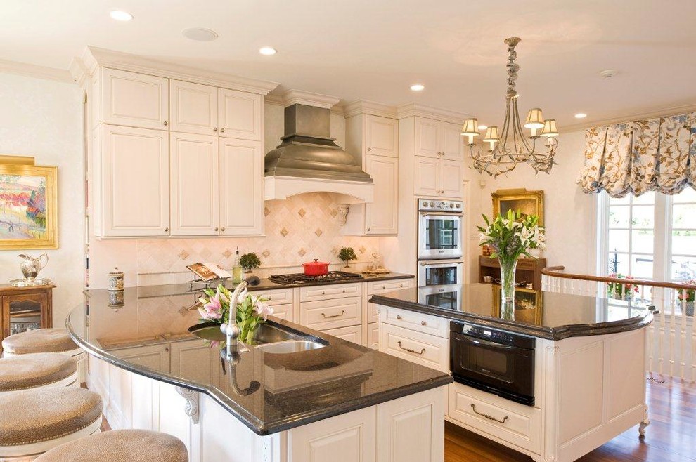 Kitchen - traditional l-shaped kitchen idea in Philadelphia with raised-panel cabinets and white cabinets