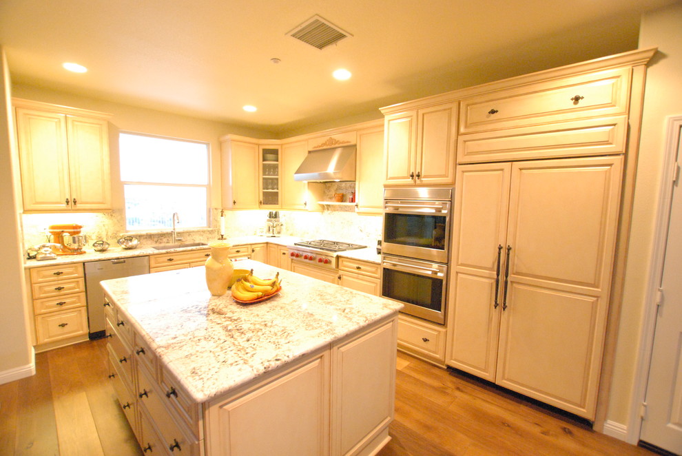 Photo of a classic kitchen in Los Angeles with integrated appliances and medium hardwood flooring.