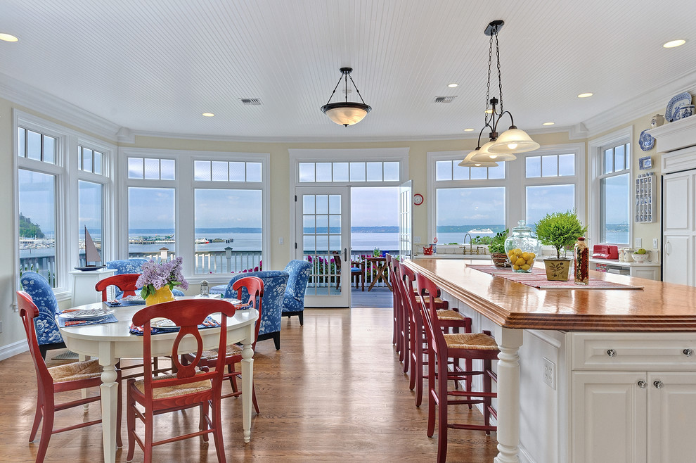 This is an example of a traditional kitchen/diner in Seattle with wood worktops and an island.