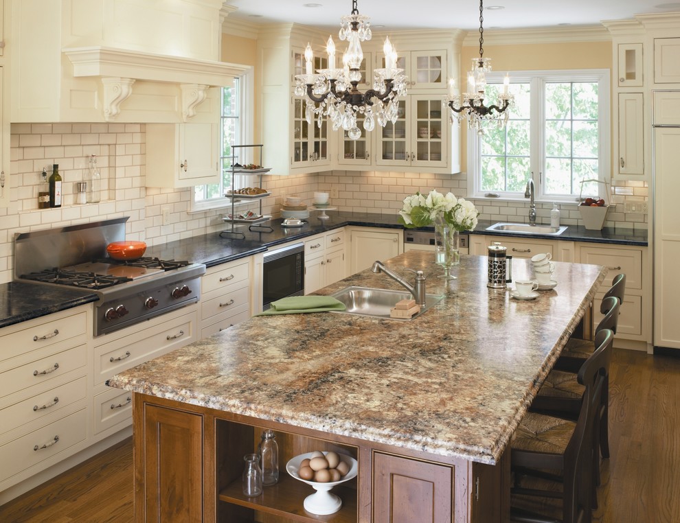 Example of a classic l-shaped kitchen design in Cincinnati with beaded inset cabinets, stainless steel appliances, a drop-in sink, white cabinets, laminate countertops, white backsplash and subway tile backsplash