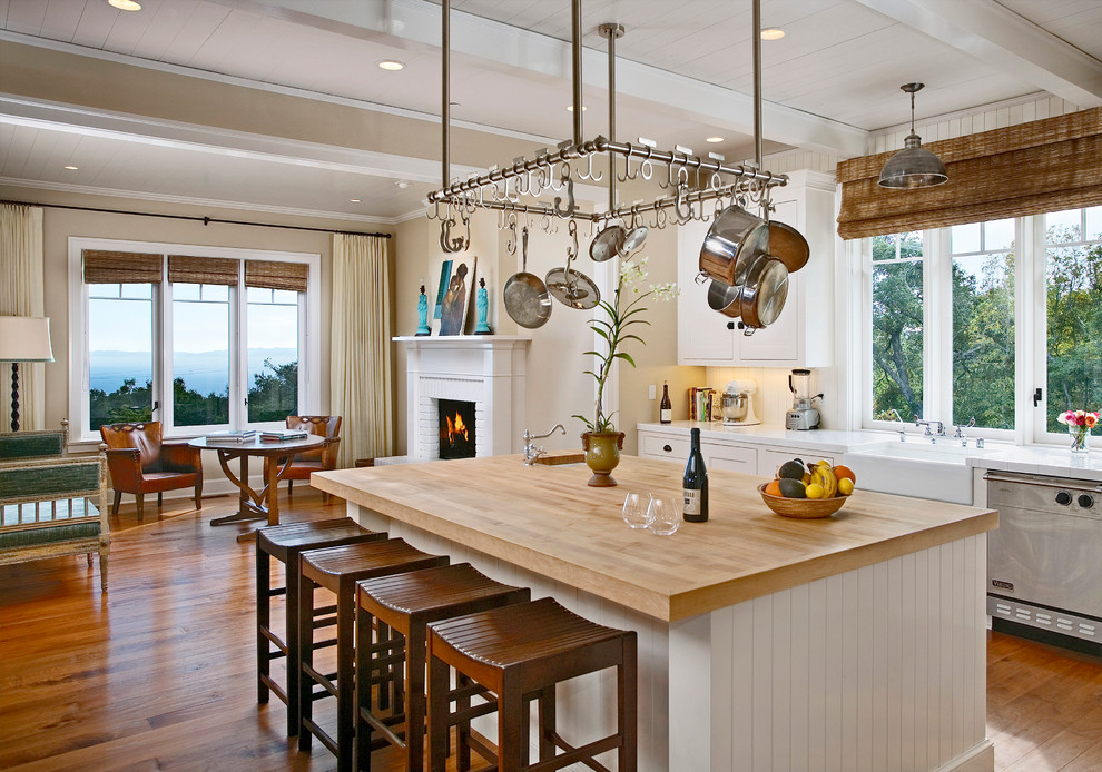 Design ideas for a classic kitchen in Santa Barbara with white cabinets, wood worktops and stainless steel appliances.