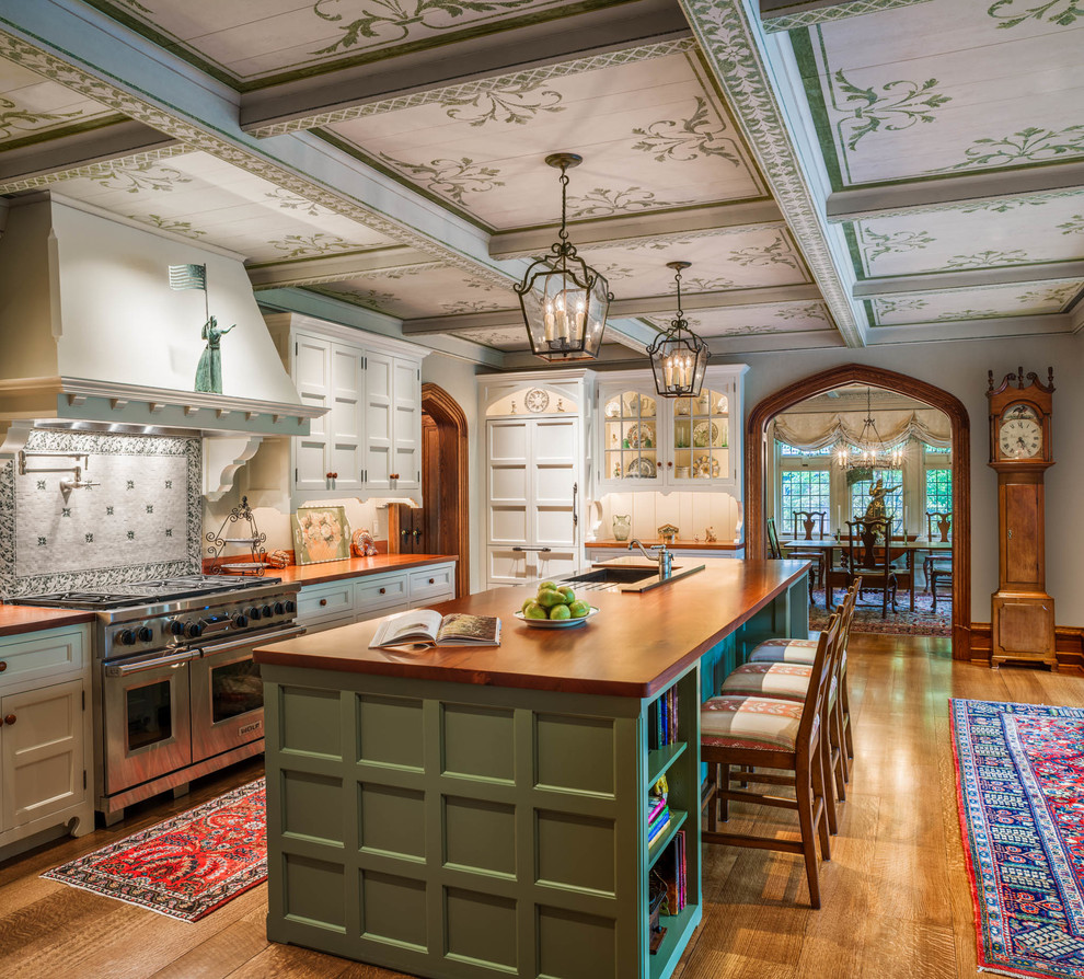 Inspiration for a traditional kitchen in Philadelphia with a submerged sink, recessed-panel cabinets, green cabinets, wood worktops, white splashback, integrated appliances, medium hardwood flooring and an island.