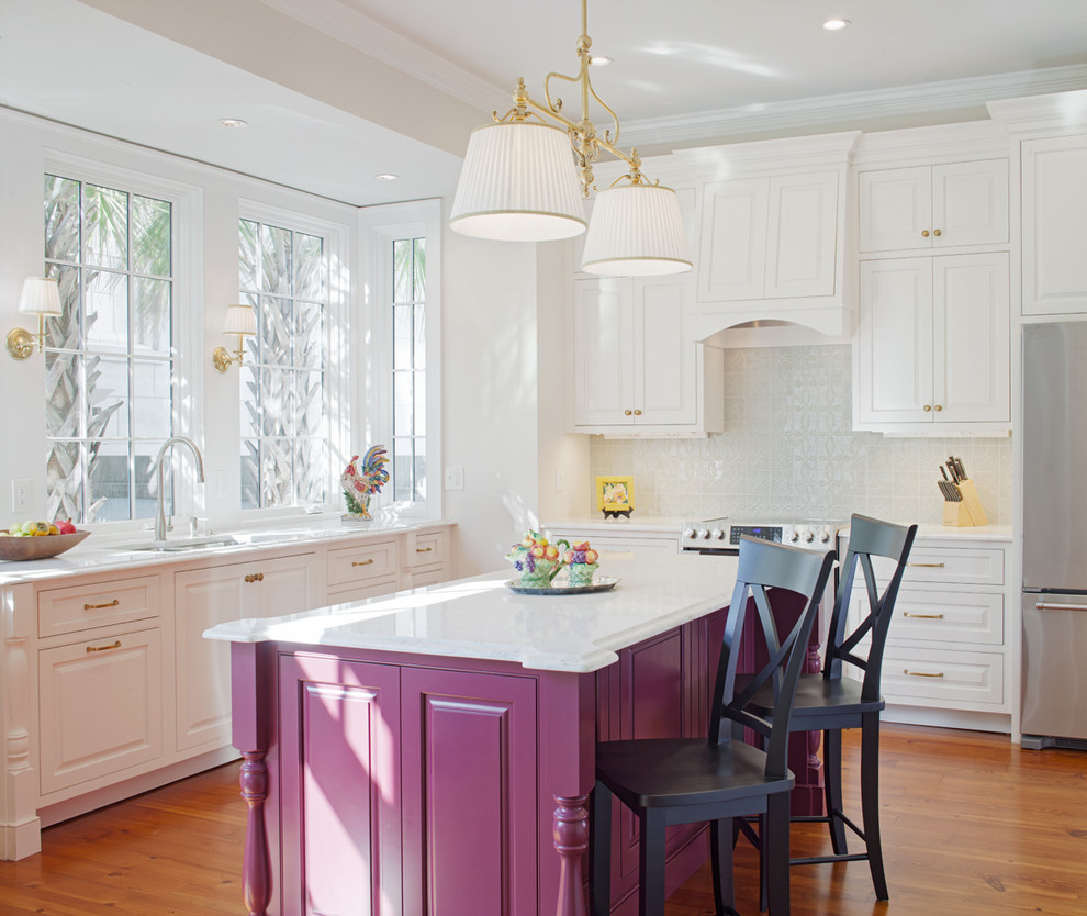 Inspiration for a medium sized traditional l-shaped enclosed kitchen in Atlanta with a submerged sink, raised-panel cabinets, engineered stone countertops, blue splashback, porcelain splashback, stainless steel appliances, medium hardwood flooring, an island, brown floors and purple cabinets.