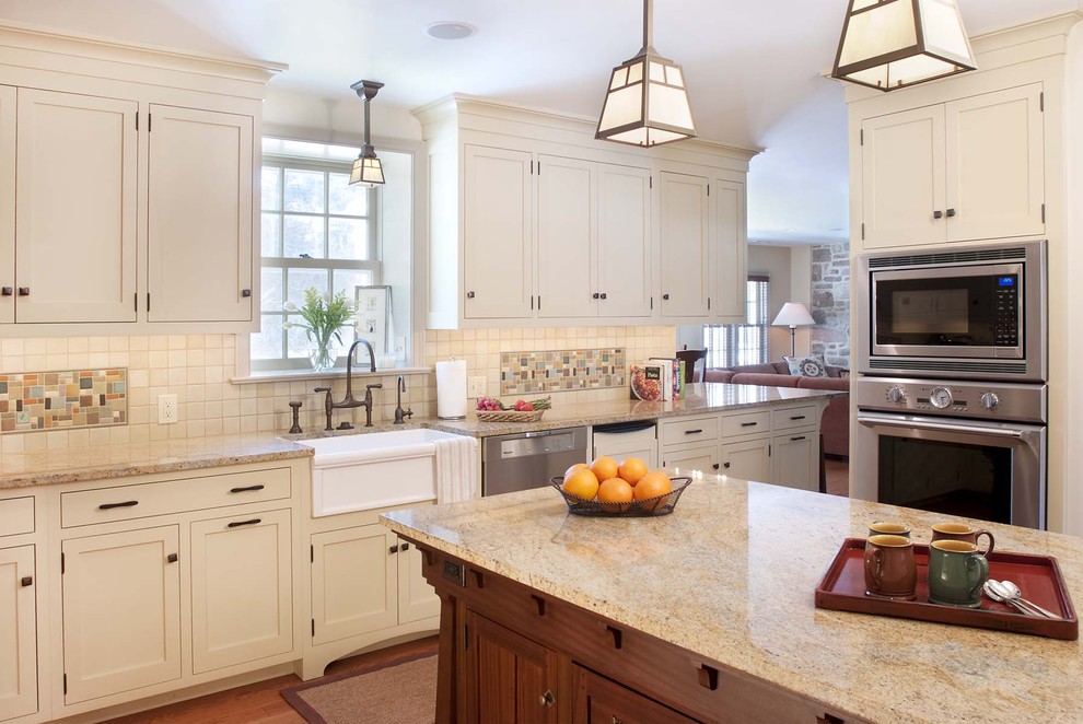 Inspiration for a craftsman kitchen remodel in Philadelphia with mosaic tile backsplash, stainless steel appliances, a farmhouse sink, multicolored backsplash and white cabinets