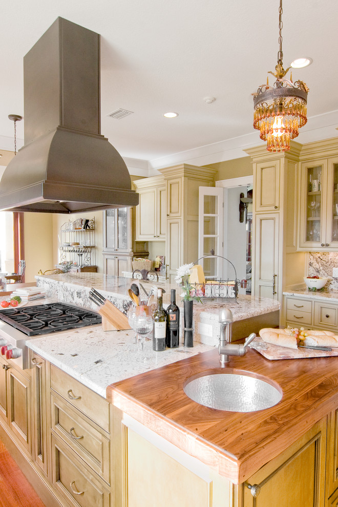 Kitchen - traditional kitchen idea in Other with beaded inset cabinets, wood countertops and an undermount sink
