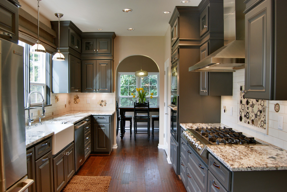 Enclosed kitchen - traditional galley enclosed kitchen idea in Other with a single-bowl sink, stainless steel appliances, raised-panel cabinets, gray cabinets, granite countertops, multicolored backsplash and ceramic backsplash