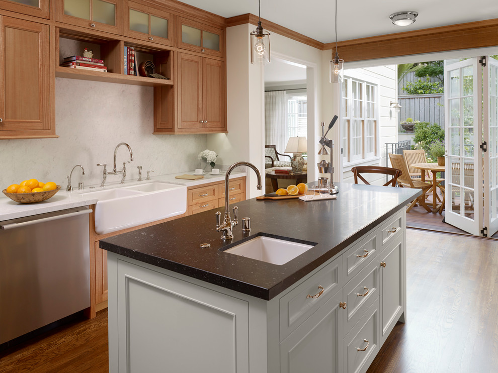 Kitchen - traditional kitchen idea in San Francisco with stainless steel appliances, a farmhouse sink and marble backsplash