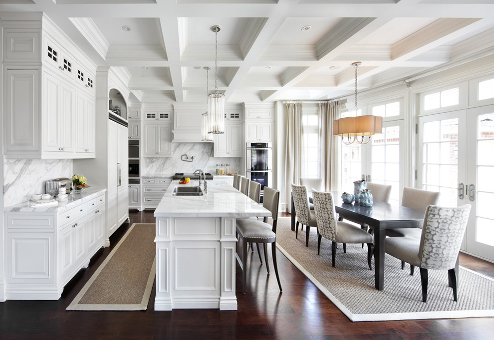 Traditional kitchen/diner in Dallas with a double-bowl sink, raised-panel cabinets, white cabinets, white splashback and integrated appliances.