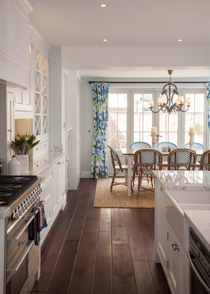 Inspiration for a timeless dark wood floor kitchen remodel in Other with a farmhouse sink and white cabinets