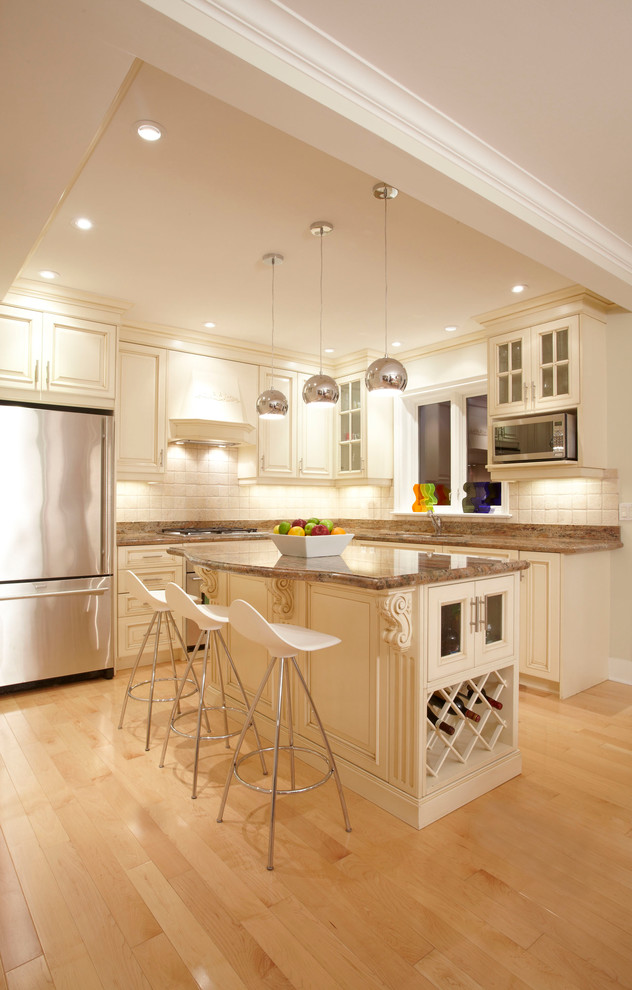 Photo of a traditional kitchen in Toronto with raised-panel cabinets.