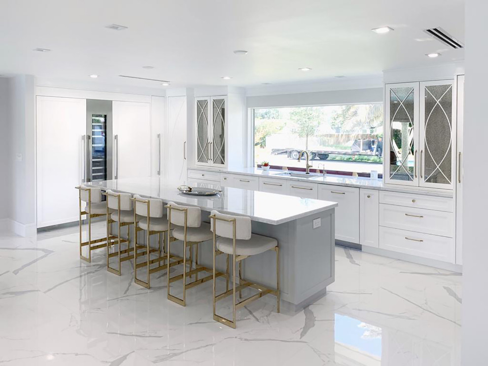 Photo of a large classic u-shaped open plan kitchen in Miami with a submerged sink, shaker cabinets, grey cabinets, engineered stone countertops, grey splashback, marble splashback, stainless steel appliances, porcelain flooring, an island, white floors and grey worktops.