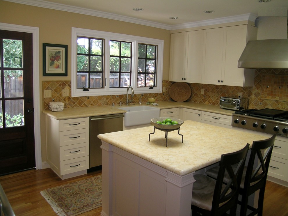 Classic kitchen in San Francisco with a belfast sink, stainless steel appliances and brown splashback.