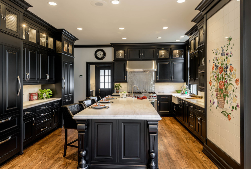 Mid-sized elegant l-shaped eat-in kitchen photo in Atlanta with a farmhouse sink, black cabinets, marble countertops, white backsplash, marble backsplash, stainless steel appliances, an island and white countertops