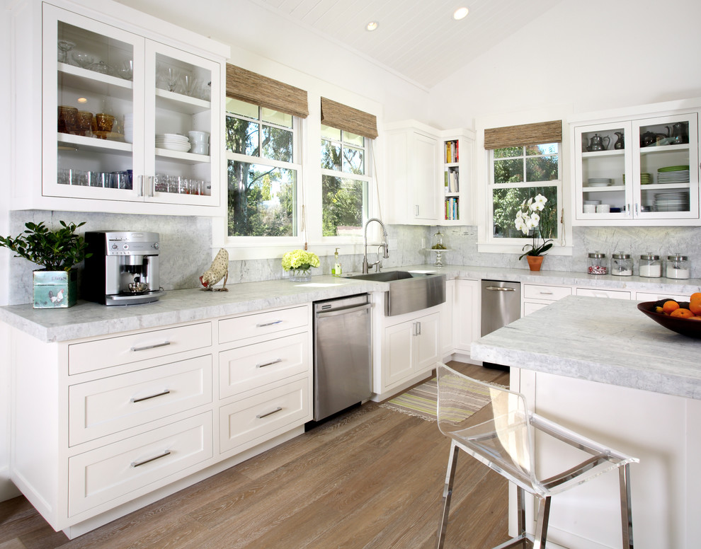 Classic kitchen in San Francisco with glass-front cabinets, stainless steel appliances and a belfast sink.