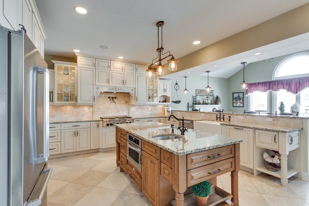 Large elegant u-shaped kitchen photo in DC Metro with a farmhouse sink, raised-panel cabinets, granite countertops, beige backsplash, stainless steel appliances and two islands