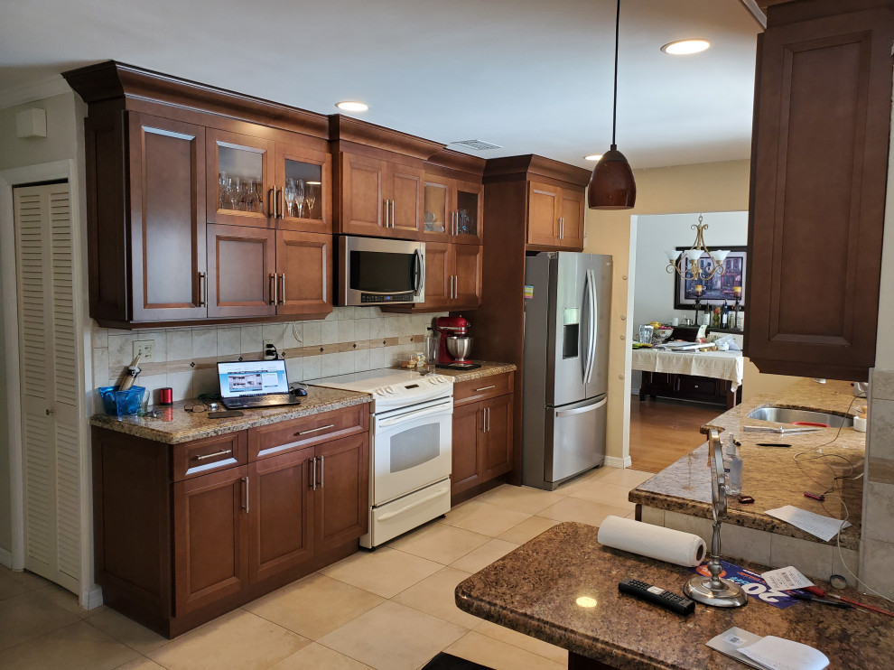Inspiration for a mid-sized timeless galley eat-in kitchen remodel in Miami with medium tone wood cabinets