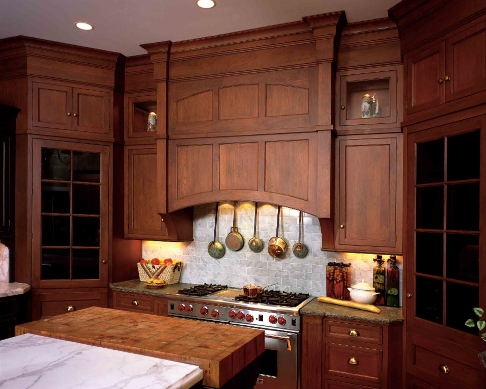Eat-in kitchen - mid-sized traditional u-shaped dark wood floor and brown floor eat-in kitchen idea in Seattle with a double-bowl sink, recessed-panel cabinets, dark wood cabinets, granite countertops, gray backsplash, ceramic backsplash, stainless steel appliances and an island