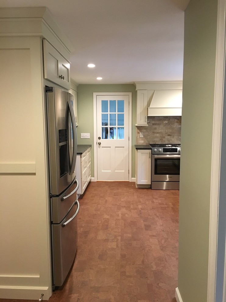 Inspiration for a mid-sized transitional l-shaped cork floor and brown floor eat-in kitchen remodel in Boston with an undermount sink, shaker cabinets, white cabinets, granite countertops, beige backsplash, stone tile backsplash, stainless steel appliances and no island