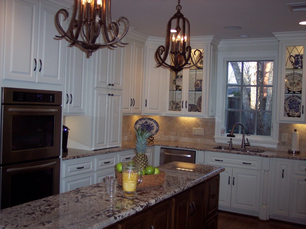 Photo of a medium sized traditional l-shaped enclosed kitchen in New Orleans with a double-bowl sink, raised-panel cabinets, beige splashback, stainless steel appliances, dark hardwood flooring and an island.