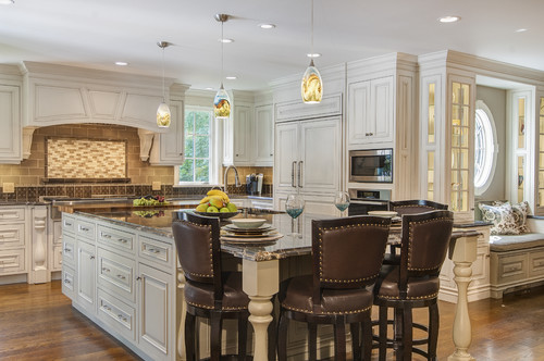 Elegant White Kitchen with Large Island and Cozy Window Seating