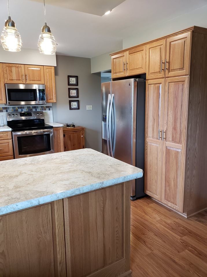 Medium sized traditional u-shaped kitchen/diner in Other with medium wood cabinets and laminate countertops.