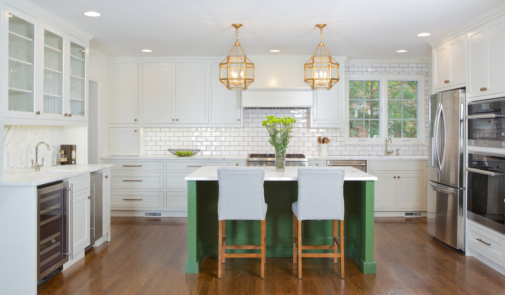 Kitchen - mid-sized traditional medium tone wood floor and orange floor kitchen idea in Atlanta with shaker cabinets, white cabinets, white backsplash, subway tile backsplash, stainless steel appliances and an island