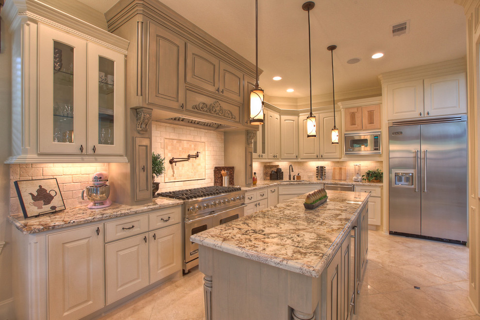 Elegant kitchen photo in Houston with glass-front cabinets and stainless steel appliances