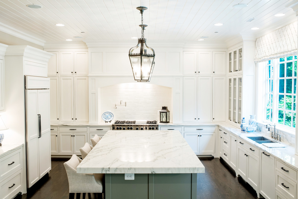 Kitchen - traditional u-shaped kitchen idea in Baltimore with a double-bowl sink, shaker cabinets, white cabinets, white backsplash, paneled appliances and gray countertops