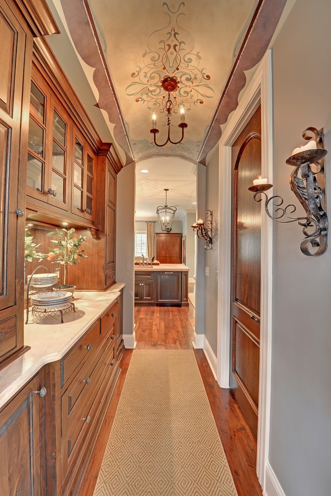 Traditional kitchen in Minneapolis with glass-front cabinets and medium wood cabinets.