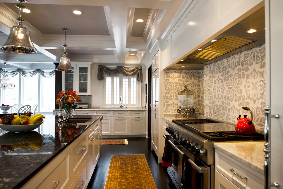 Elegant kitchen photo in Newark with mosaic tile backsplash, stainless steel appliances, multicolored backsplash, white cabinets and recessed-panel cabinets