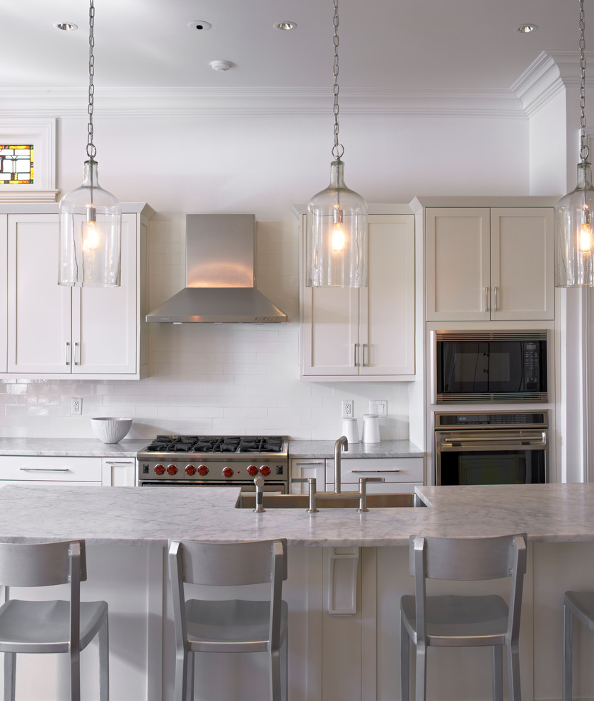 Kitchen - traditional kitchen idea in New Orleans with shaker cabinets and marble countertops